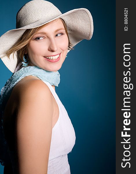 Beautiful woman in a hat isolated on blue background. Beautiful woman in a hat isolated on blue background