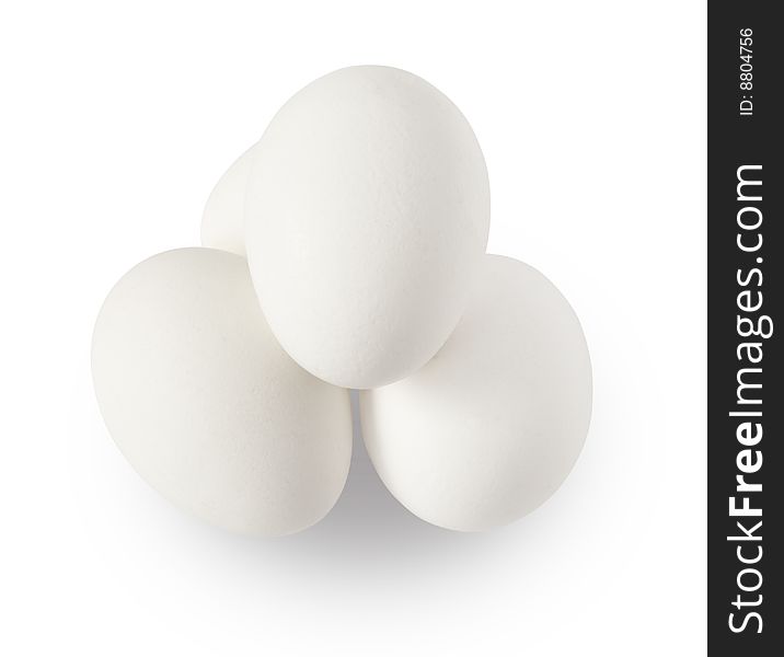 Four piled eggs isolated on white background