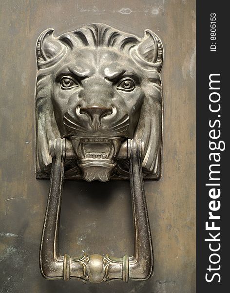 Ancient bronze lion head door knocker with hinged bar