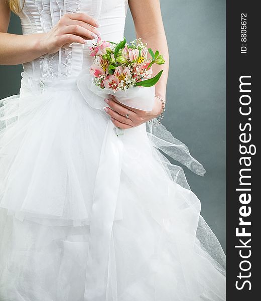 Elegant wedding bouquet at bride's hands