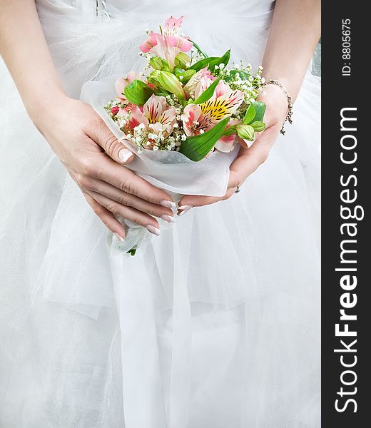 Elegant wedding bouquet at bride's hands