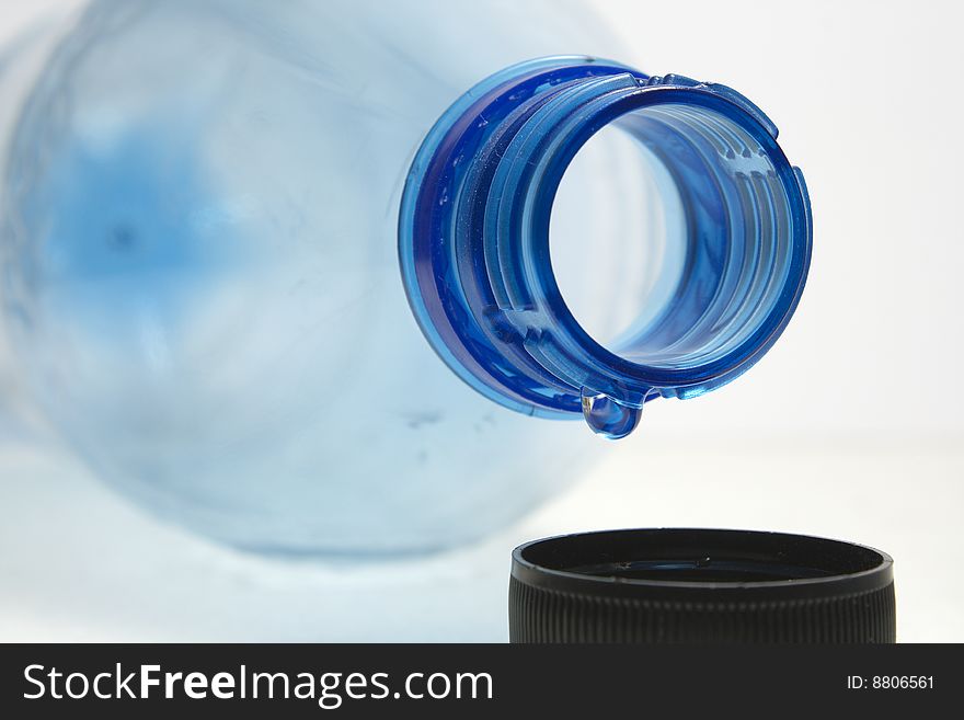 Last drop of empty water bottle on white background. Last drop of empty water bottle on white background