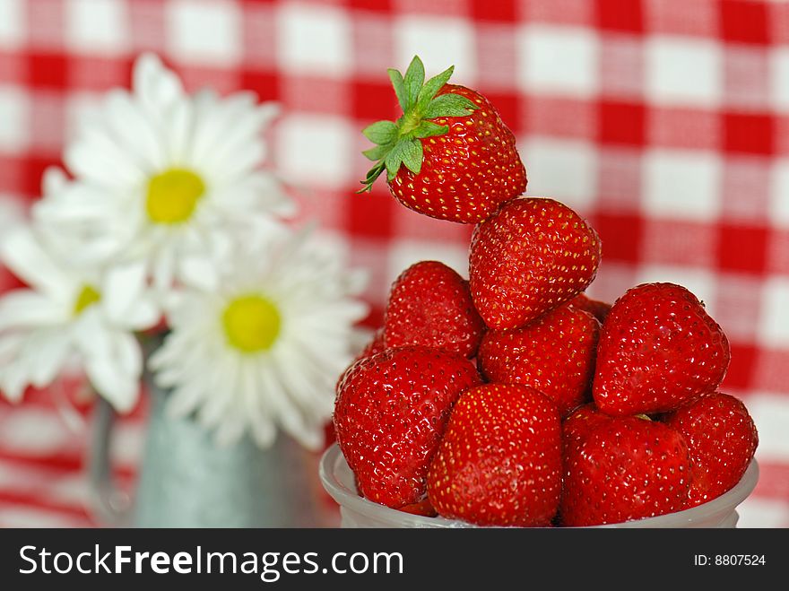 Bowl of fresh strawberries with daisy bouquet. Bowl of fresh strawberries with daisy bouquet.