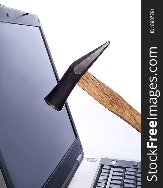 Hammer breaking laptop screen - informational poisoning stress concept. Hammer breaking laptop screen - informational poisoning stress concept