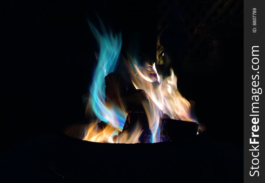 Colourful flames dancing, swirling in a bed of coals, could it be fire spirits?