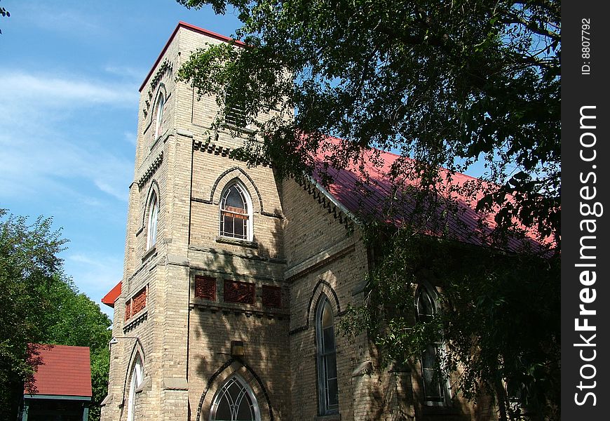 An old church in the woods, doors are open for prayers.