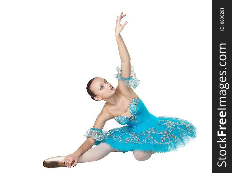 Ballerina Sits On A Floor In A Graceful Pose