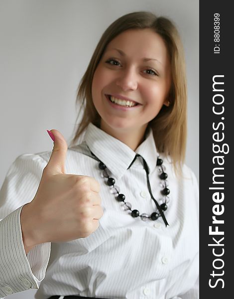 Beautiful businesswoman with her thumb up