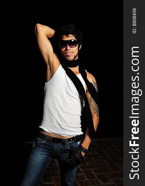 Portrait of young male fashion model with arm tattoo and sunglasses. Portrait of young male fashion model with arm tattoo and sunglasses