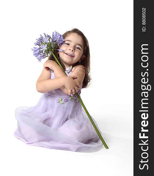 Little girl arms wrapped around a large agapanthus lily flower. Little girl arms wrapped around a large agapanthus lily flower.