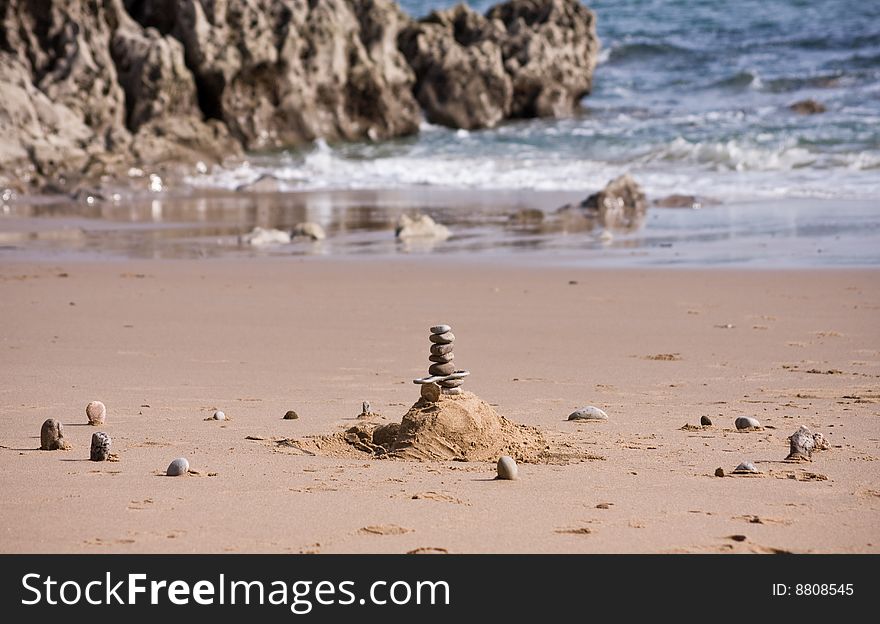Piled up pebbles on a sandy beach. Piled up pebbles on a sandy beach