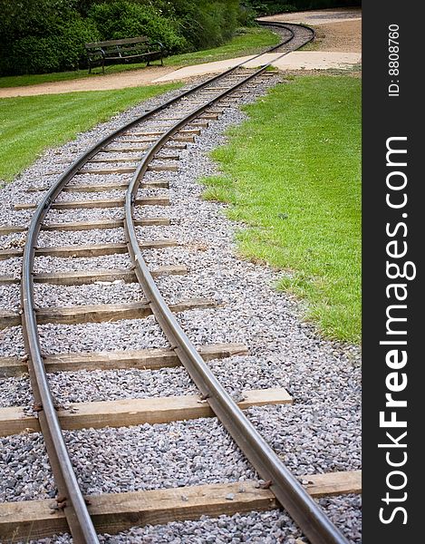 Miniture railway track curving into the distance. Miniture railway track curving into the distance.