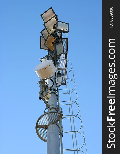 Stadium light pole in blue sky background