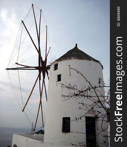 A white-washed windmill looking towards the sea on the greek island of Santorini. A white-washed windmill looking towards the sea on the greek island of Santorini