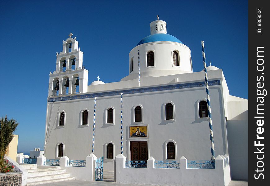 A small white-washed greek orthodox church in a small village of Oia, Santorini Island