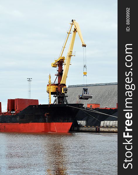 Cargo ship loading in a dock