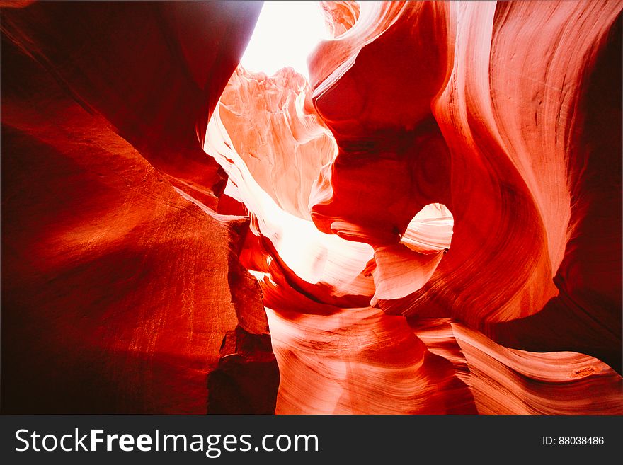 Abstract artistic background created by a canyon and rock formation illuminated by orange and white light, dark background. Abstract artistic background created by a canyon and rock formation illuminated by orange and white light, dark background.