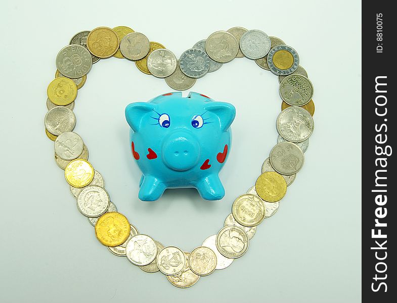 Piggy bank with coins, isolated on white.