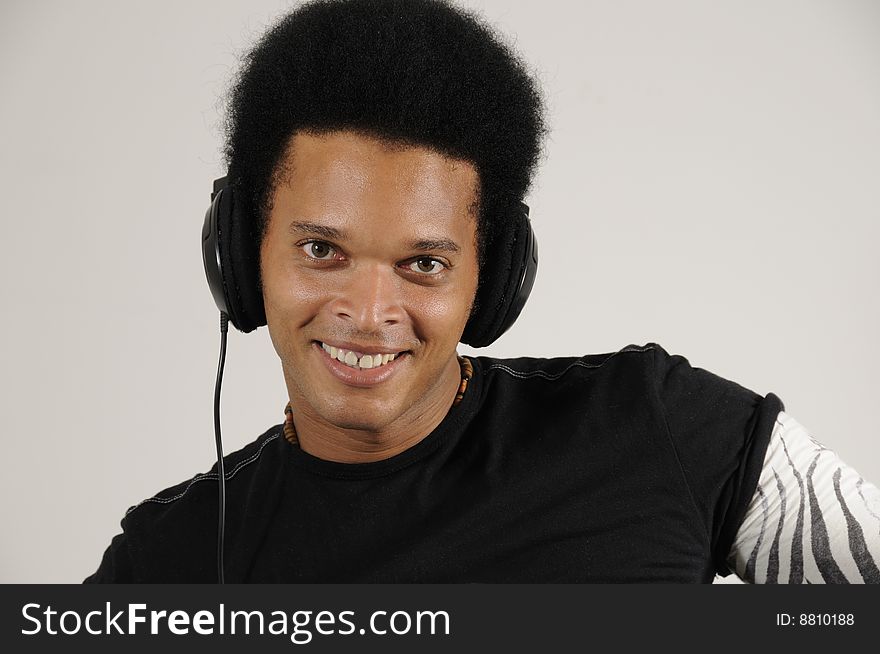 Portrait of young trendy african holding headphones with happy expression. Portrait of young trendy african holding headphones with happy expression