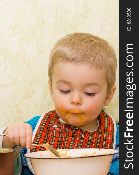 Cute little boy eating squash