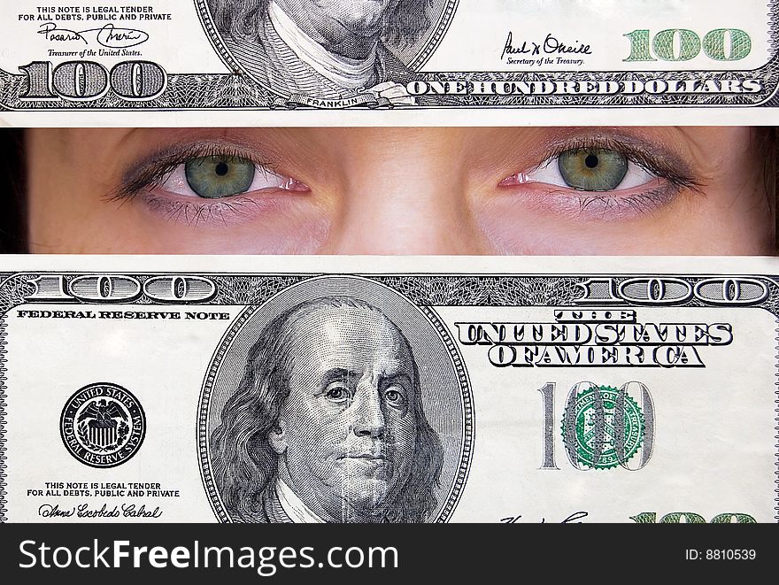 Green female eyes looking through hundred dollars banknote. Green female eyes looking through hundred dollars banknote.