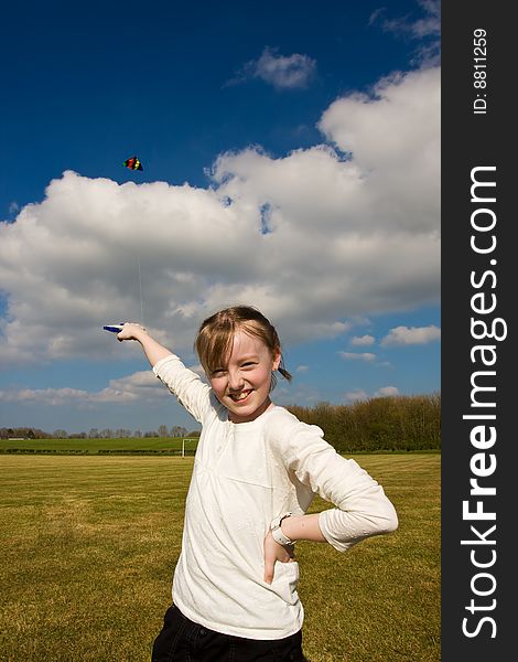 Young girl playing with kite poses for camera. Young girl playing with kite poses for camera