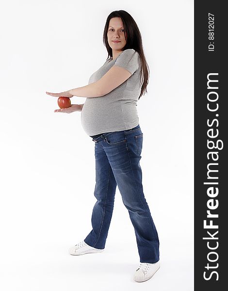 Pregnant woman with red apple isolated on white back ground