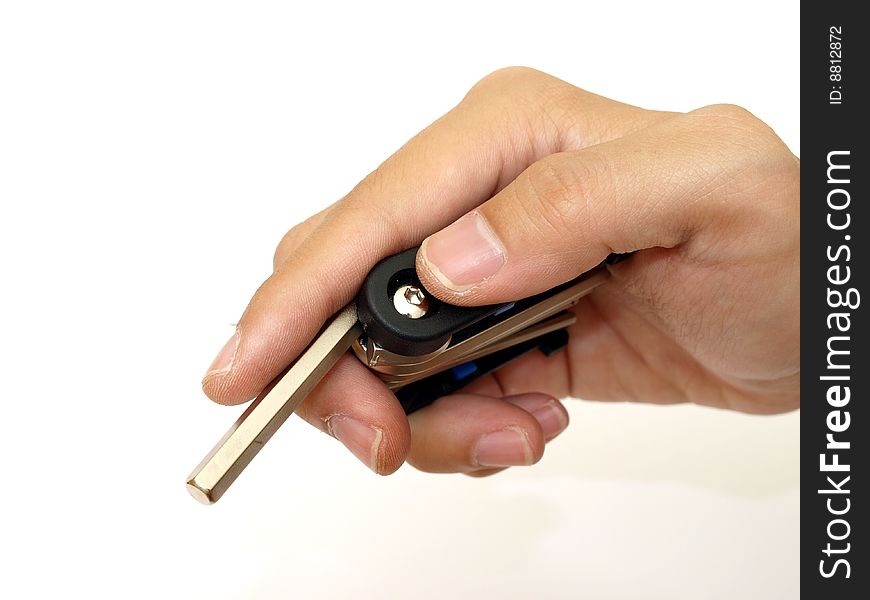 Pocket cyclist hex key in male hand on white background. Pocket cyclist hex key in male hand on white background