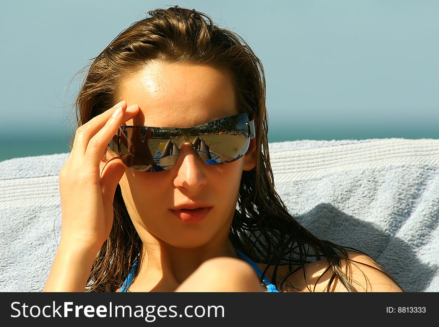 Woman in sunglasses on the beach