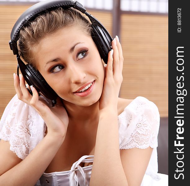 Young sexy women listening music in headphones