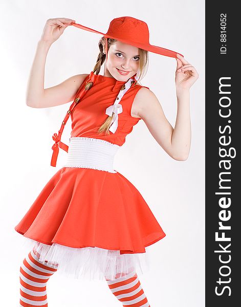 Playful pretty girl in red dress and hat. Playful pretty girl in red dress and hat