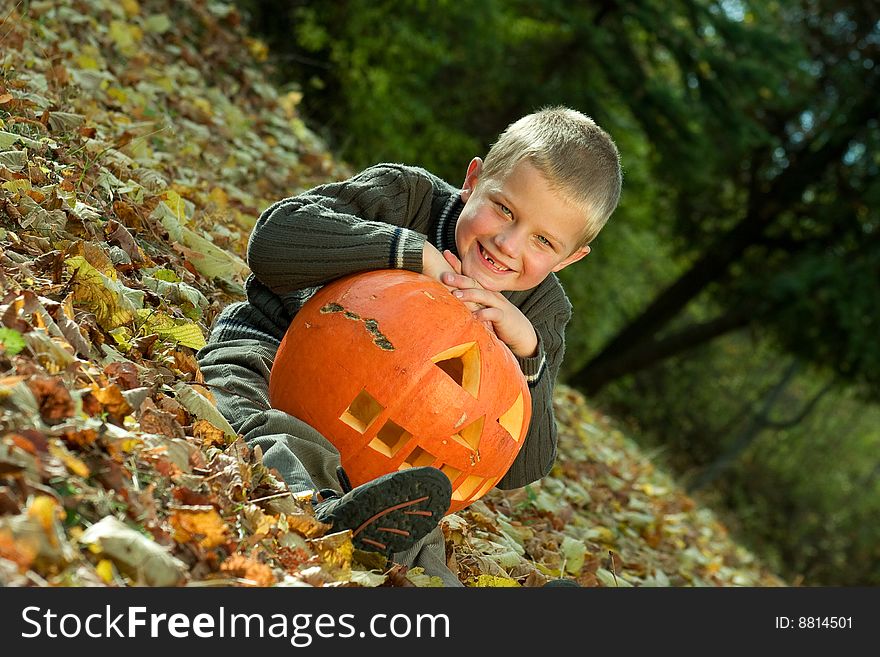 Smiling little boy with halloween pumpkin. Smiling little boy with halloween pumpkin