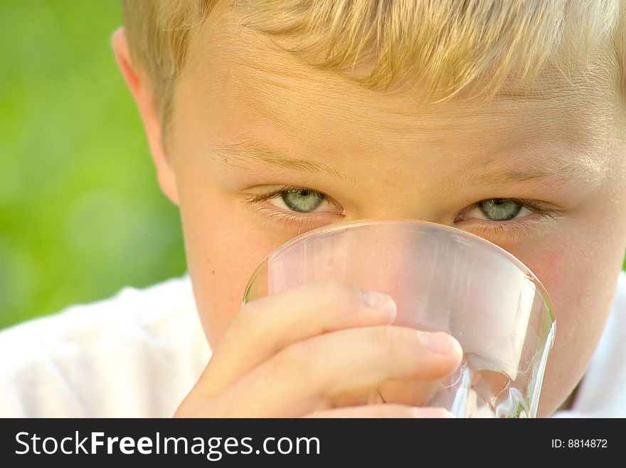 Shot of a boy drinking a glass of fresh orange juice. Shot of a boy drinking a glass of fresh orange juice