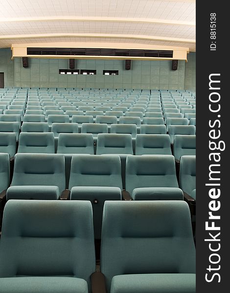 Empty new cinema auditorium with rows of green chairs. Empty new cinema auditorium with rows of green chairs.