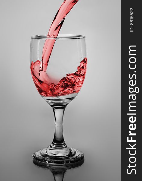 Glass of pouring water with wine