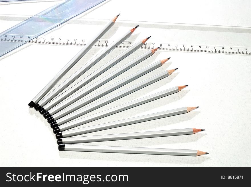 A set of drawing pencils and a rulers