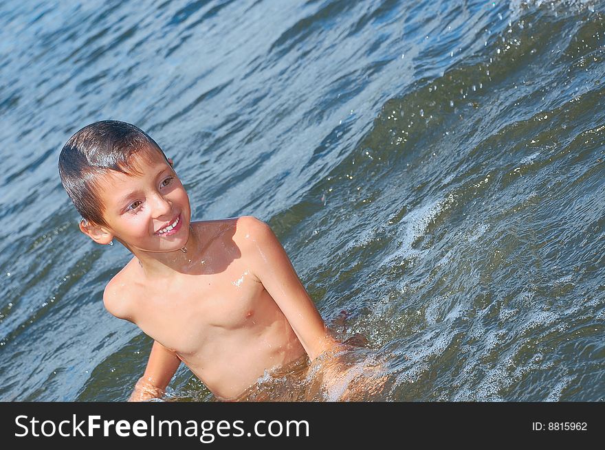 Happy boy having fun in the river water. Happy boy having fun in the river water