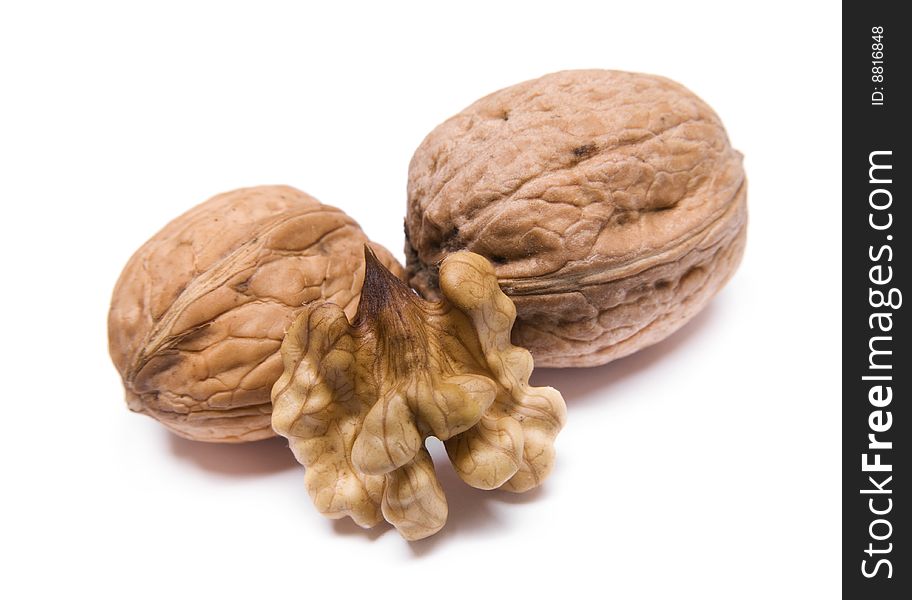 Two walnuts closeup on white