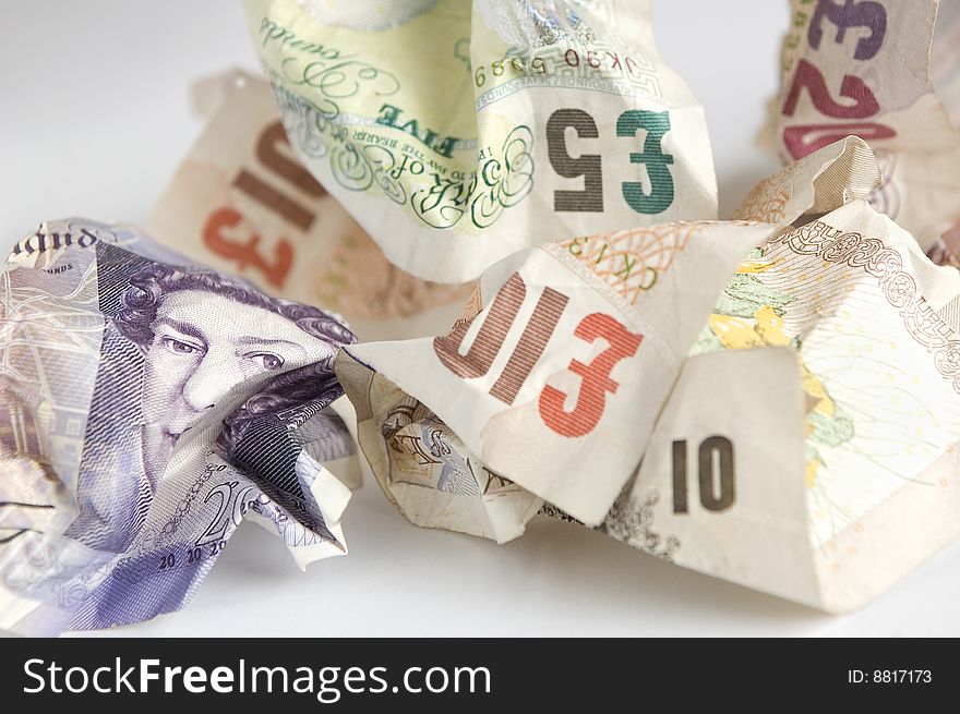 Crumpled British pound (Sterling) banknotes with the face of Queen Elizabeth in focus. Studio shot, horizontal composition. Crumpled British pound (Sterling) banknotes with the face of Queen Elizabeth in focus. Studio shot, horizontal composition.