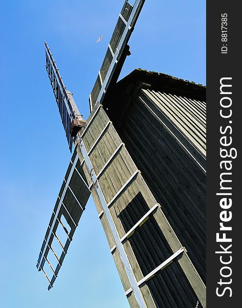 Old wooden windmill and the blue sky