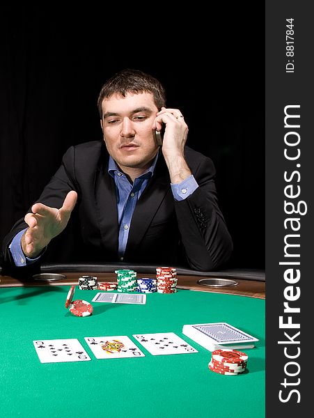 Attractive young caucasian man make bet in the casino. Attractive young caucasian man make bet in the casino