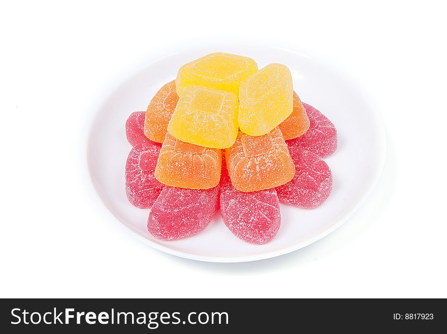 Multicoloured gumdrops on white saucer, isolated on white. Multicoloured gumdrops on white saucer, isolated on white