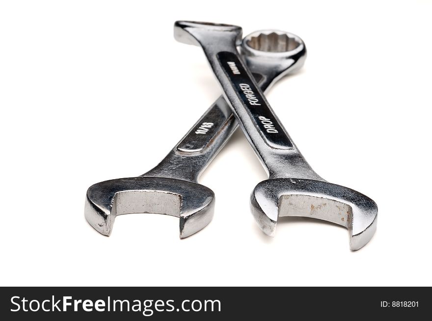Horizontal image of a pair of old worn combination wrenches