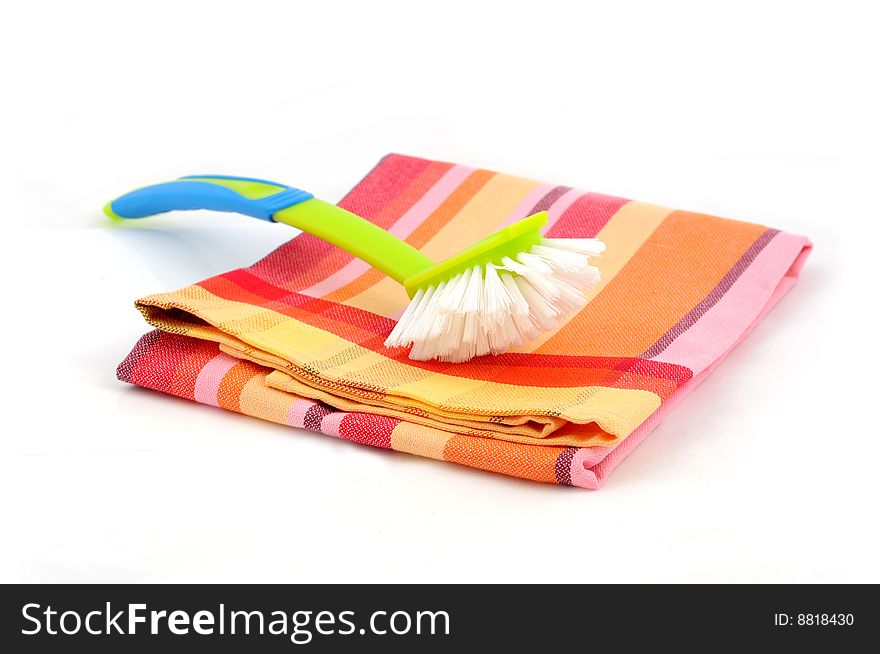 Dishtowel and cleaning brush isolated on white background