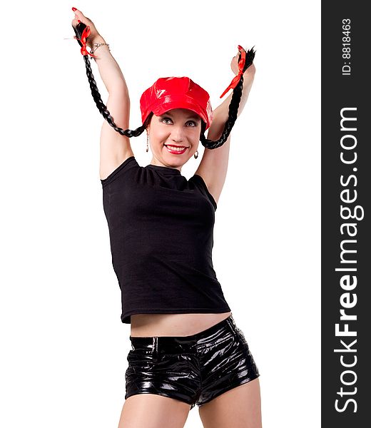 A young woman in black shorts and red lacquer lacquered cap dances. A young woman in black shorts and red lacquer lacquered cap dances.