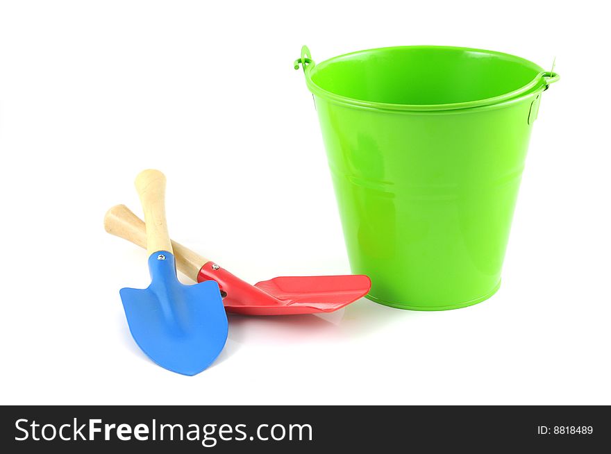 Green bucket with garden tools isolated on white background