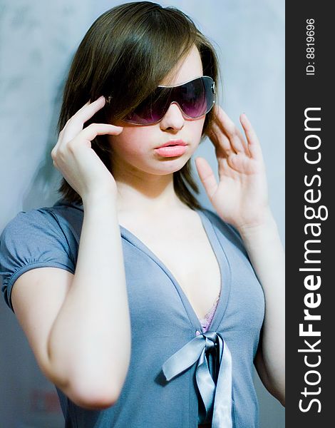 Beautiful girl in blue and in dark sunglasses. Beautiful girl in blue and in dark sunglasses