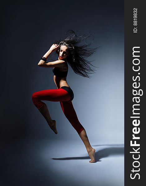 Modern style dancer posing behind studio background. Modern style dancer posing behind studio background