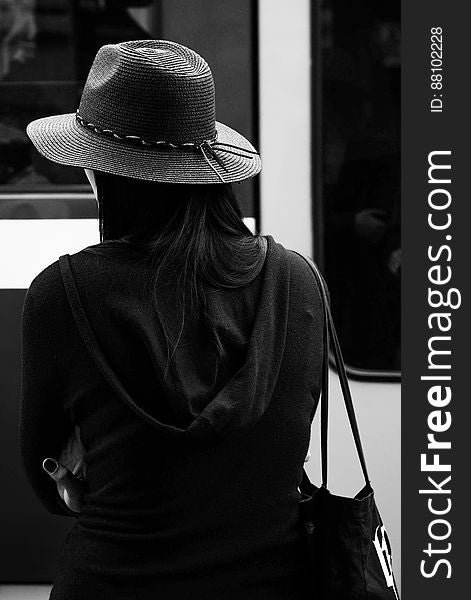 Greyscale Photo of a Woman Wearing a Hat
