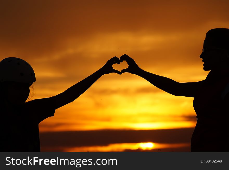 Silhouette of Man Touching Woman Against Sunset Sky